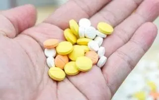 Colorful pills and drugs in close up. Assorted pills and drugs in medicine. Opioid and prescription medication addiction epidemic. Drugs of various kinds.